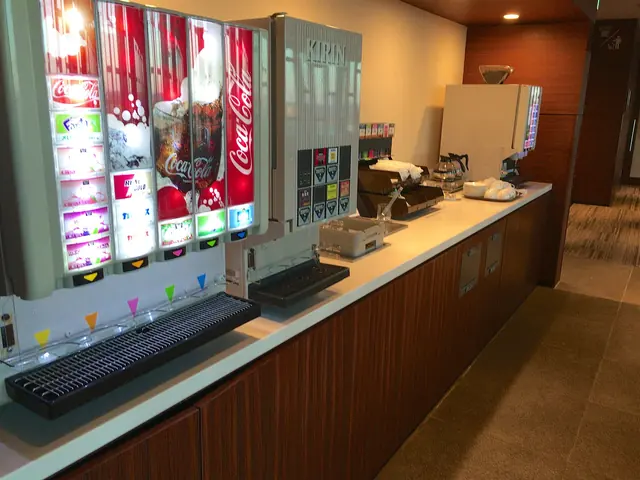 Self-service soft drink machines and a coffee machine along a counter