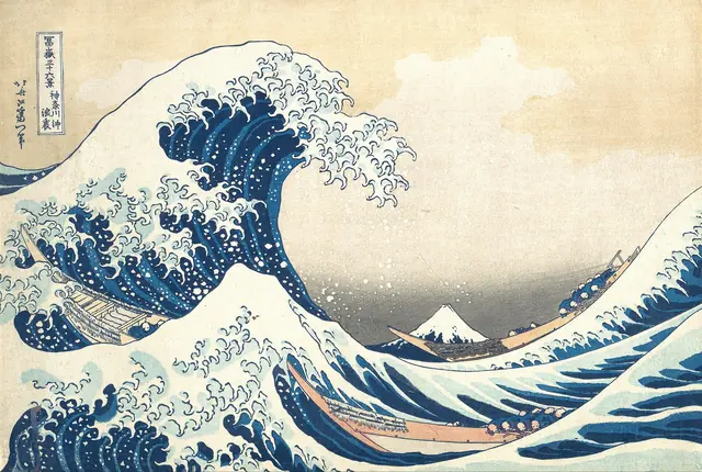 Hokusai's woodblock print of a great wave curling over boats with Mount Fuji small in the distance