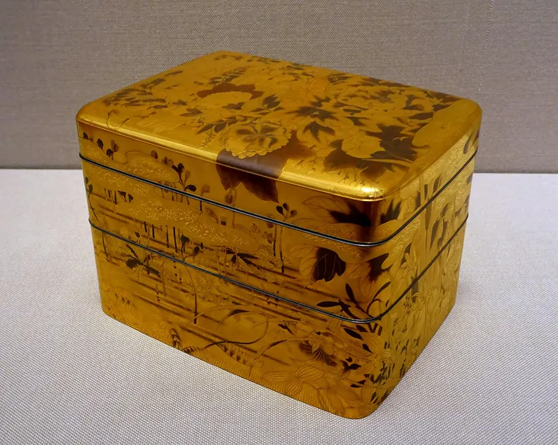 A gold lacquer box with lids, decorated with flowers in gold