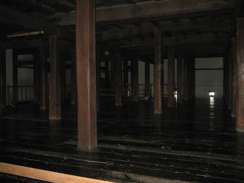Dark wooden pillars and polished floorboards inside the keep of Matsumoto Castle