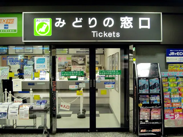 A JR ticket office front with a sign reading みどりの窓口 Tickets, glass doors and leaflet racks