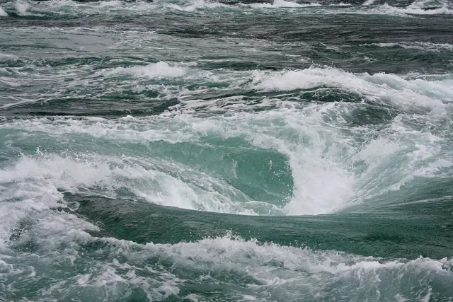 A whirlpool in rough green water