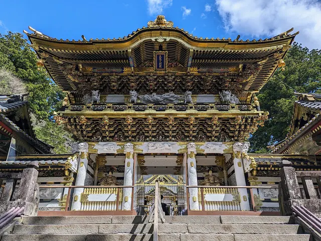 The ornate gold-and-white Yomeimon Gate at the top of stone steps