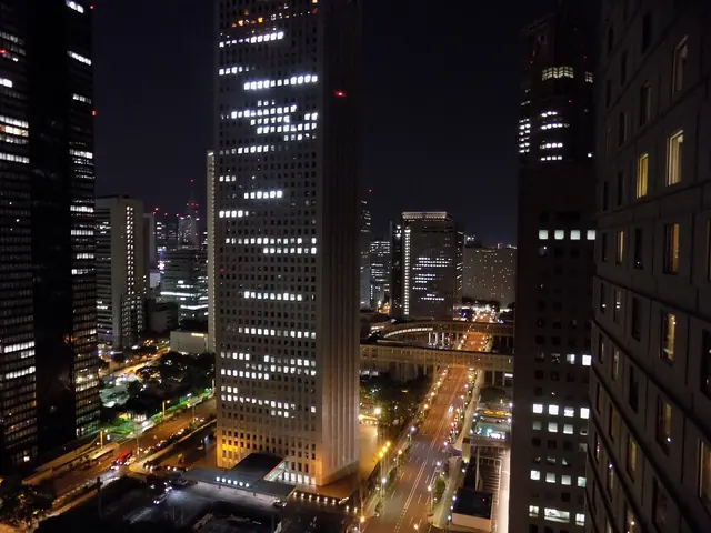 Lit skyscrapers in Nishi-Shinjuku at night seen from above